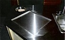stainless-steel countertop w/cut-out for trash bin, recessed holder for cutting board