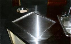stainless-steel countertop w:cut-out for trash bin, recessed holder for cutting board